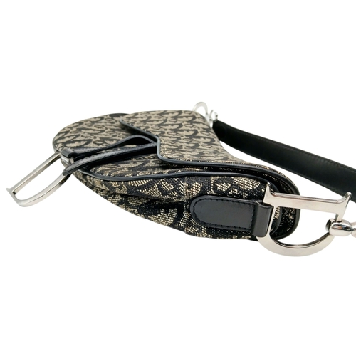 83 - A Christian Dior Saddle Canvas Bag. Black and cream  exterior with Dior monogram decoration througho... 