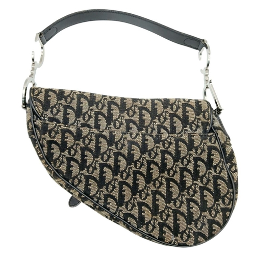 83 - A Christian Dior Saddle Canvas Bag. Black and cream  exterior with Dior monogram decoration througho... 