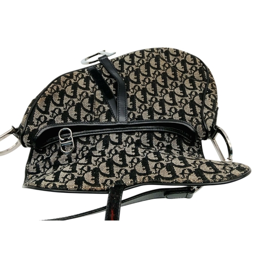 83 - A Christian Dior Saddle Canvas Bag. Black and cream  exterior with Dior monogram decoration througho... 