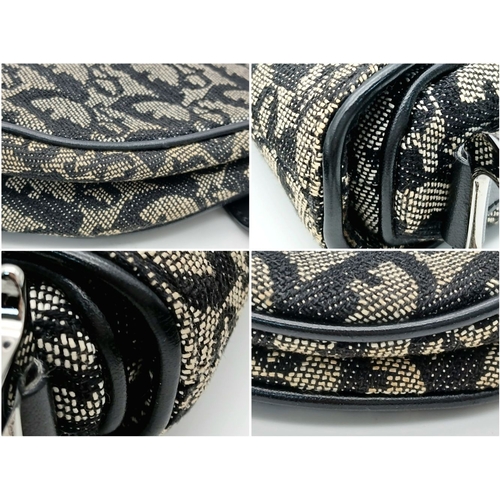 83 - A Christian Dior Saddle Canvas Bag. Black and cream  exterior with Dior monogram decoration througho... 