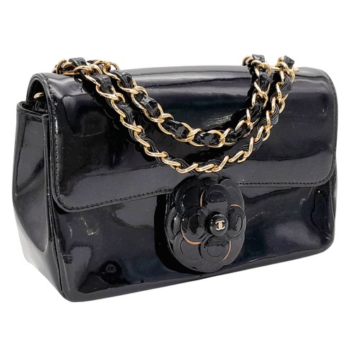 69 - A Chanel Camellia Flap Bag in Black Patent Leather. Exterior open pocket. Gold tone hardware. Classi... 
