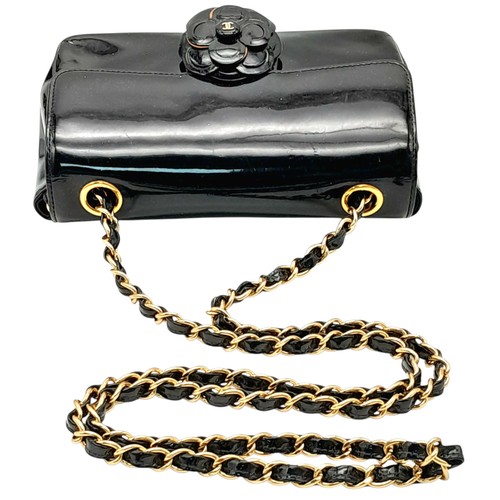 69 - A Chanel Camellia Flap Bag in Black Patent Leather. Exterior open pocket. Gold tone hardware. Classi... 