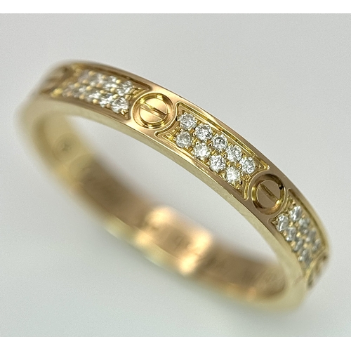 29 - An 18K Gold and Diamond Pave Cartier Love Band Ring. 4mm width. Size 50. 2.1g. Comes with a Cartier ... 