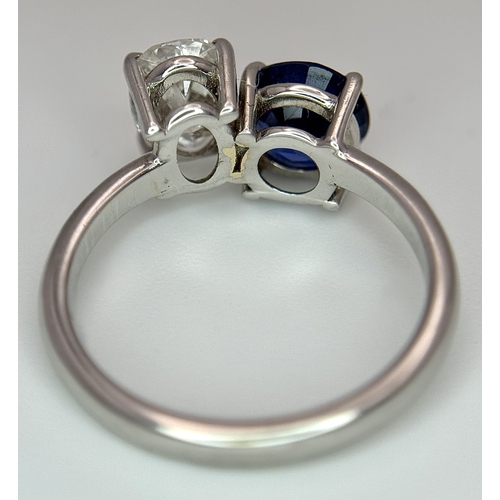 120 - A Spectacular W.G.I Certified 18K White Gold Sapphire and Diamond Ring. An oval cut 1.01ct diamond a... 