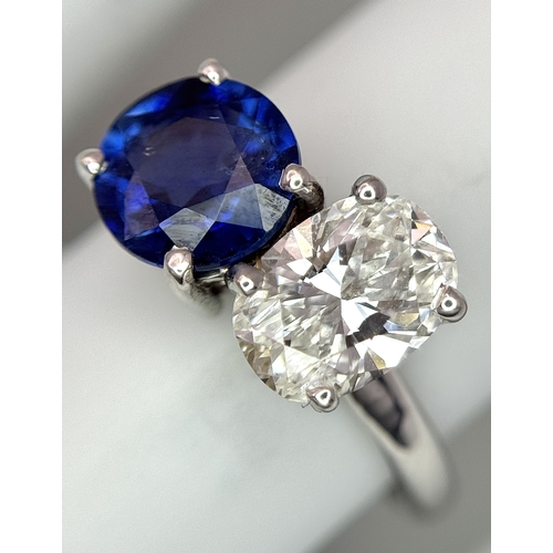 120 - A Spectacular W.G.I Certified 18K White Gold Sapphire and Diamond Ring. An oval cut 1.01ct diamond a... 