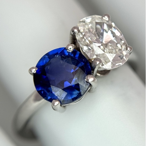 120 - A Spectacular W.G.I Certified 18K White Gold Sapphire and Diamond Ring. An oval cut 1.01ct diamond a... 