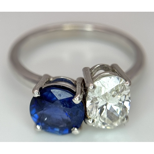 120 - A Spectacular W.G.I Certified 18K White Gold Sapphire and Diamond Ring. An oval cut 1.01ct diamond a... 
