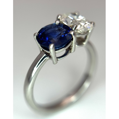 120 - A Spectacular W.G.I Certified 18K White Gold Sapphire and Diamond Ring. An oval cut 1.01ct diamond a... 