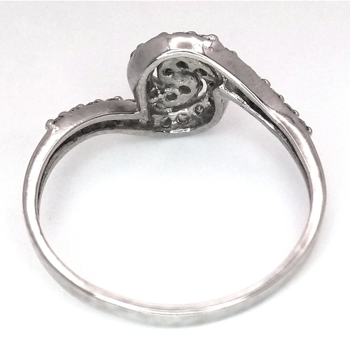 96 - AN 18K WHITE GOLD DIAMOND SET SPIRAL RING - 0.25CTW. 2.2G. SIZE M. SC6062.