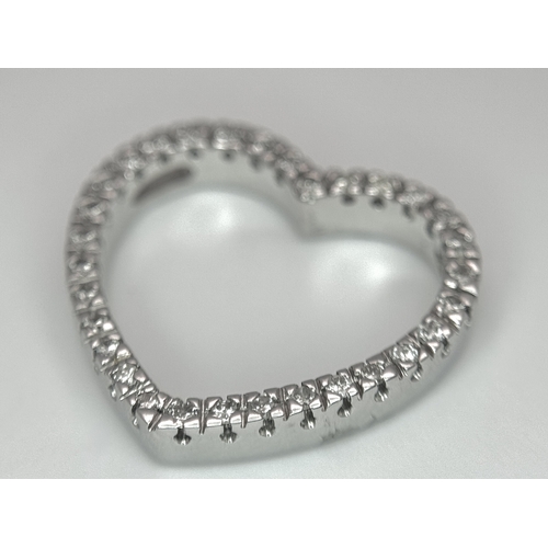 68 - AN 18K WHITE GOLD DIAMOND SET HEART PENDANT. 0.25CTW. 3.3G. SC6058.