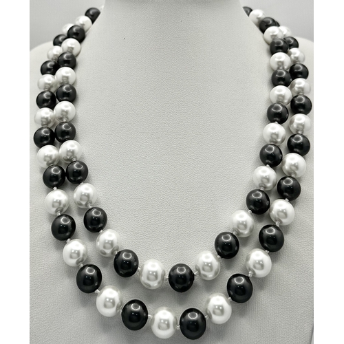 1094 - A Matinee Length Black and White South Sea Shell Pearl Necklace. 10mm beads. 90cm necklsce length.