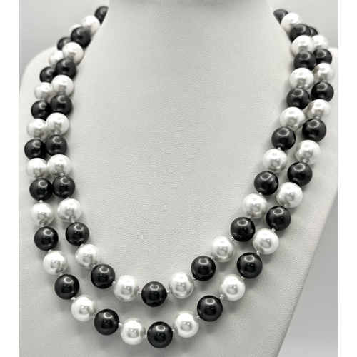 1094 - A Matinee Length Black and White South Sea Shell Pearl Necklace. 10mm beads. 90cm necklsce length.