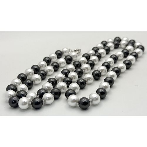 1094 - A Matinee Length Black and White South Sea Shell Pearl Necklace. 10mm beads. 90cm necklsce length.
