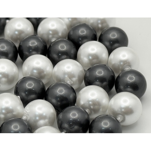 1094 - A Matinee Length Black and White South Sea Shell Pearl Necklace. 10mm beads. 90cm necklsce length.
