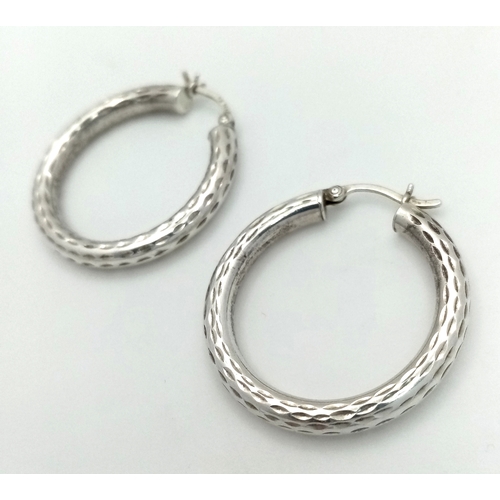 1286 - A 925 silver pair of textured fashion hoop earrings. Total weight 3.4G.