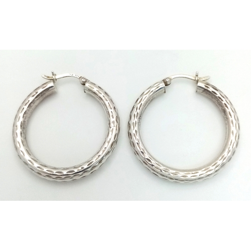 1286 - A 925 silver pair of textured fashion hoop earrings. Total weight 3.4G.