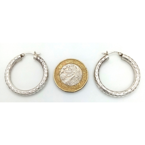 1286 - A 925 silver pair of textured fashion hoop earrings. Total weight 3.4G.
