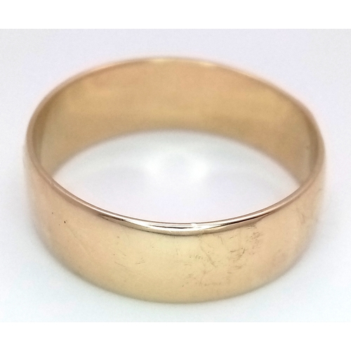32 - A Large 9K Yellow Gold Band Ring. 9mm width. Size Z +6. 7.7g.