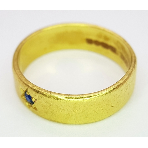 50 - A 22K Yellow Gold Band Ring with Sapphire Star Set Gemstone. 6mm width. Size J. 4.3g.