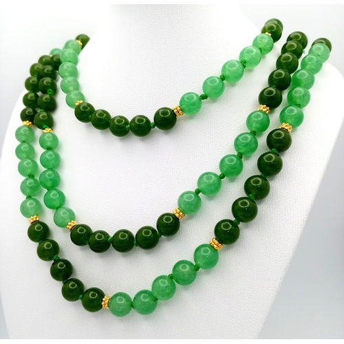 529 - A Rope Length Jade Necklace. Two shades of green. 150cm necklace length.