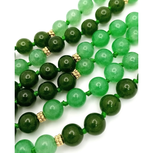 529 - A Rope Length Jade Necklace. Two shades of green. 150cm necklace length.