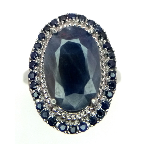 527 - A 5ct Blue Sapphire Ring with a halo of Blue Sapphire Accents. Set in 925 Silver. Size M 1/2. With c... 