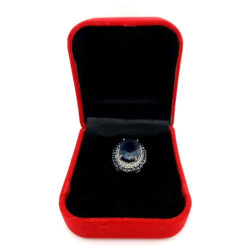 527 - A 5ct Blue Sapphire Ring with a halo of Blue Sapphire Accents. Set in 925 Silver. Size M 1/2. With c... 