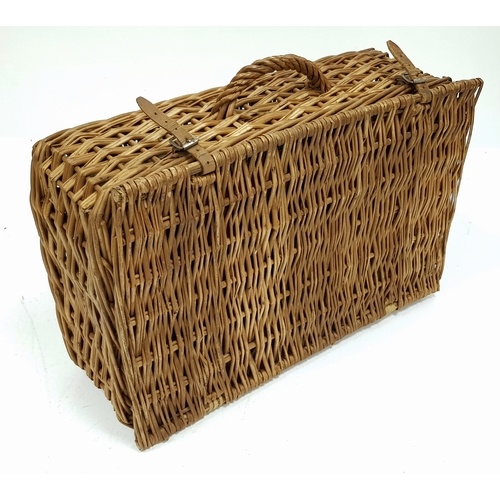 780 - A vintage wicker picnic basket with buckle fasteners, containing two original Thermos flasks, and fo... 