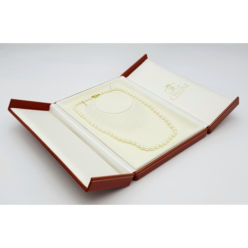 22 - A Cellini Rice Pearl Necklace with 18K Gold Clasp. 44cm length. Comes with a Cellini case.