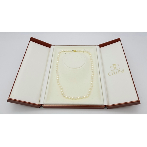 22 - A Cellini Rice Pearl Necklace with 18K Gold Clasp. 44cm length. Comes with a Cellini case.