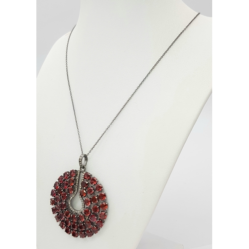 572 - A Garnet Gemstone Large Circular Pendant. Set in 925 Silver. 
5.5cm diameter. Comes with a silver ch... 