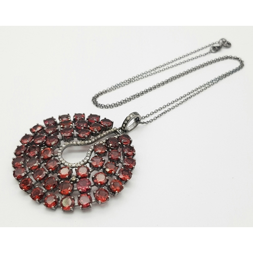 572 - A Garnet Gemstone Large Circular Pendant. Set in 925 Silver. 
5.5cm diameter. Comes with a silver ch... 