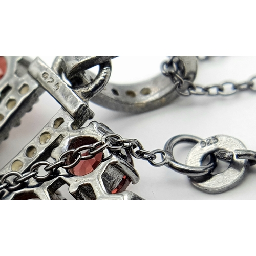 572 - A Garnet Gemstone Large Circular Pendant. Set in 925 Silver. 
5.5cm diameter. Comes with a silver ch... 