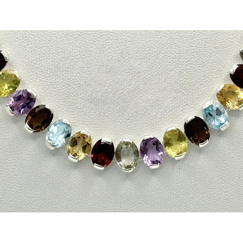 682 - An Amethyst, Citrine, Blue Topaz, Garnet and Peridot Gemstone Necklace. Set in 925 Silver. 44cm leng... 