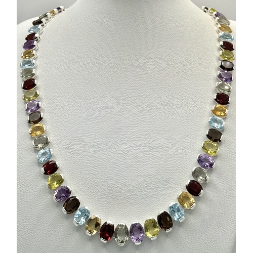 682 - An Amethyst, Citrine, Blue Topaz, Garnet and Peridot Gemstone Necklace. Set in 925 Silver. 44cm leng... 