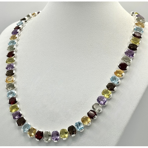 682 - An Amethyst, Citrine, Blue Topaz, Garnet and Peridot Gemstone Necklace. Set in 925 Silver. 44cm leng... 