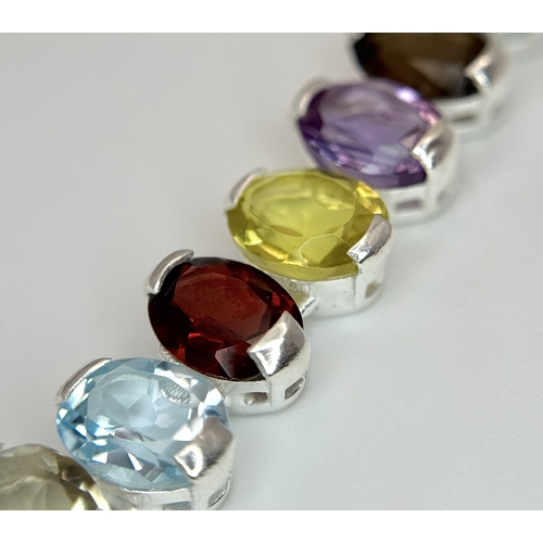 682 - An Amethyst, Citrine, Blue Topaz, Garnet and Peridot Gemstone Necklace. Set in 925 Silver. 44cm leng... 