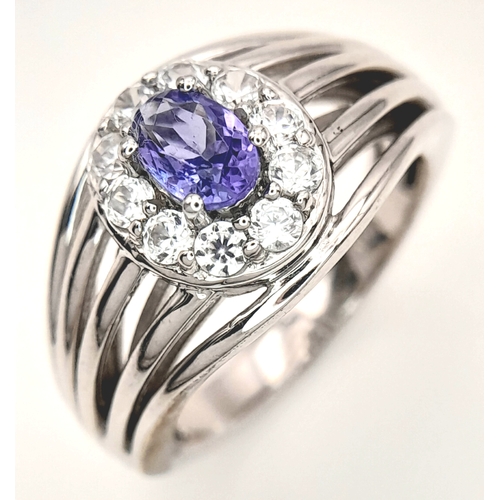 1706 - An Impressive Sterling Silver Tanzanite and White Topaz Ring Size P. The Ring is set with a 7mm Oval... 