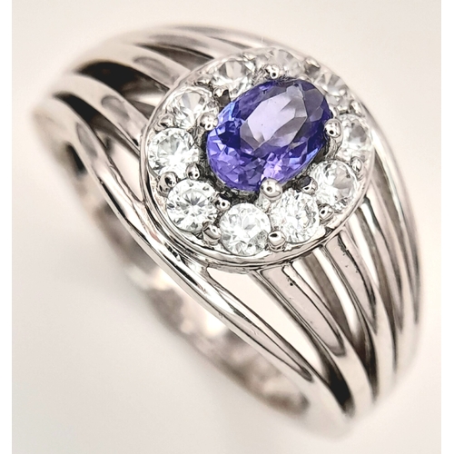 1706 - An Impressive Sterling Silver Tanzanite and White Topaz Ring Size P. The Ring is set with a 7mm Oval... 