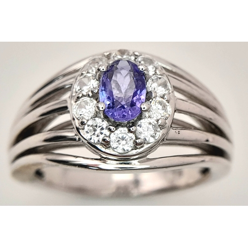 1706 - An Impressive Sterling Silver Tanzanite and White Topaz Ring Size P. The Ring is set with a 7mm Oval... 