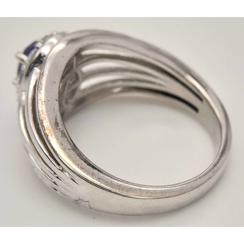1706 - An Impressive Sterling Silver Tanzanite and White Topaz Ring Size P. The Ring is set with a 7mm Oval... 