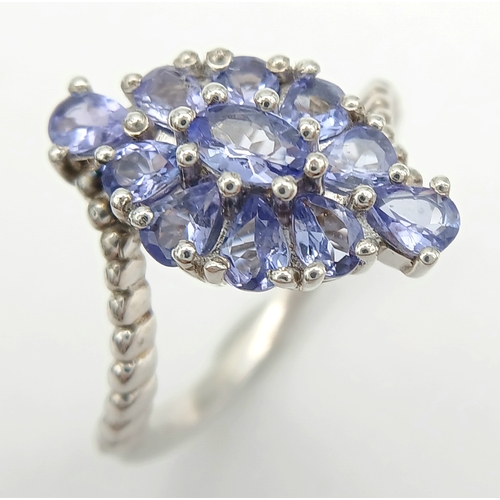 1683 - A Pretty Art Deco Style Sterling Silver Tanzanite Set Crossover Ring Size P. The Ring is set with Ov... 