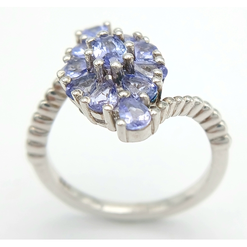 1683 - A Pretty Art Deco Style Sterling Silver Tanzanite Set Crossover Ring Size P. The Ring is set with Ov... 