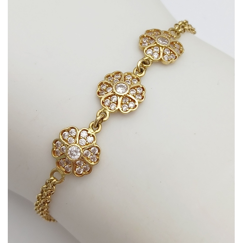211 - An 18K YELLOW GOLD DIAMOND SET TRIPLE FLOWER BRACELET 3.9G. Ref: TAN 7022