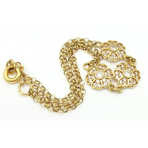 211 - An 18K YELLOW GOLD DIAMOND SET TRIPLE FLOWER BRACELET 3.9G. Ref: TAN 7022