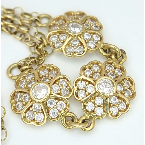 211 - An 18K YELLOW GOLD DIAMOND SET TRIPLE FLOWER BRACELET 3.9G. Ref: TAN 7022