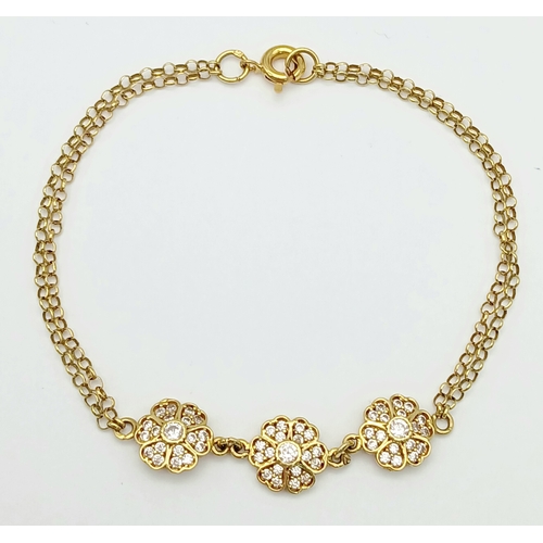 211 - An 18K YELLOW GOLD DIAMOND SET TRIPLE FLOWER BRACELET 3.9G. Ref: TAN 7022