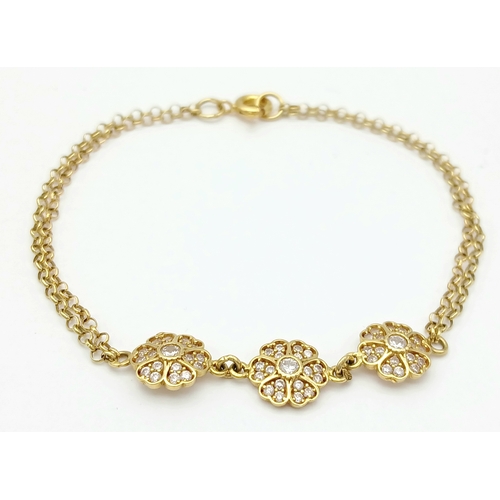 211 - An 18K YELLOW GOLD DIAMOND SET TRIPLE FLOWER BRACELET 3.9G. Ref: TAN 7022