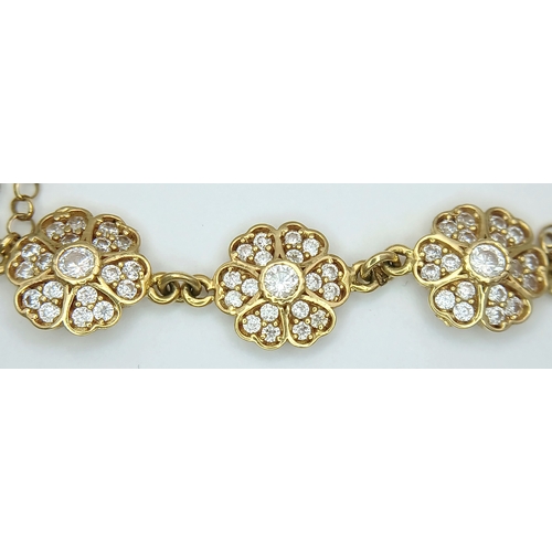 211 - An 18K YELLOW GOLD DIAMOND SET TRIPLE FLOWER BRACELET 3.9G. Ref: TAN 7022