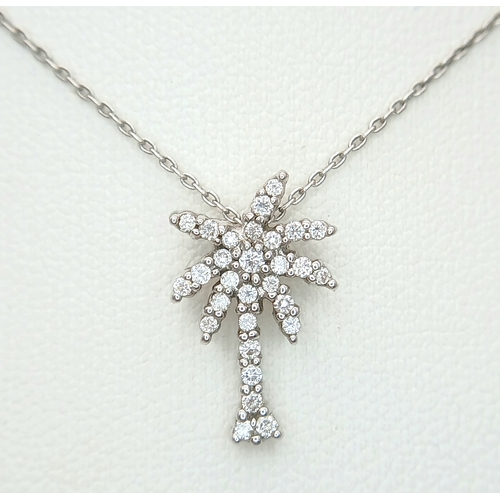 386 - An 18K WHITE GOLD DIAMOND SET PALM TREE PENDANT ON CHAIN 2.5G. Ref: TAN 7021